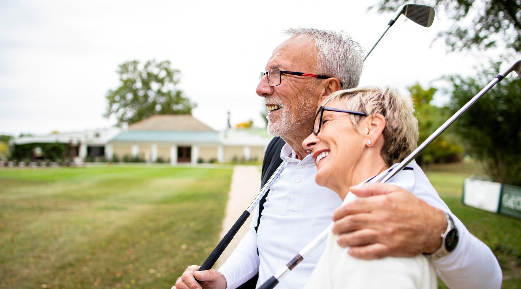 two people holding gold clubs