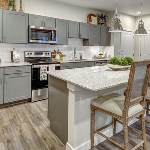 Beautiful kitchens with designer finishes a kitchen with island and chairs