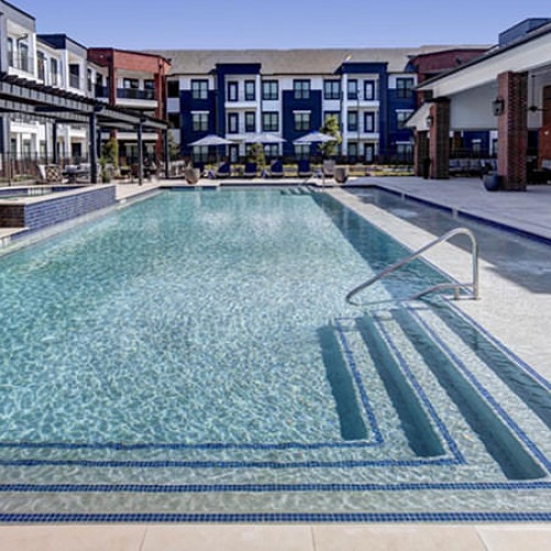 Shimmering resort-style pool resort-style pool with tanning ledge